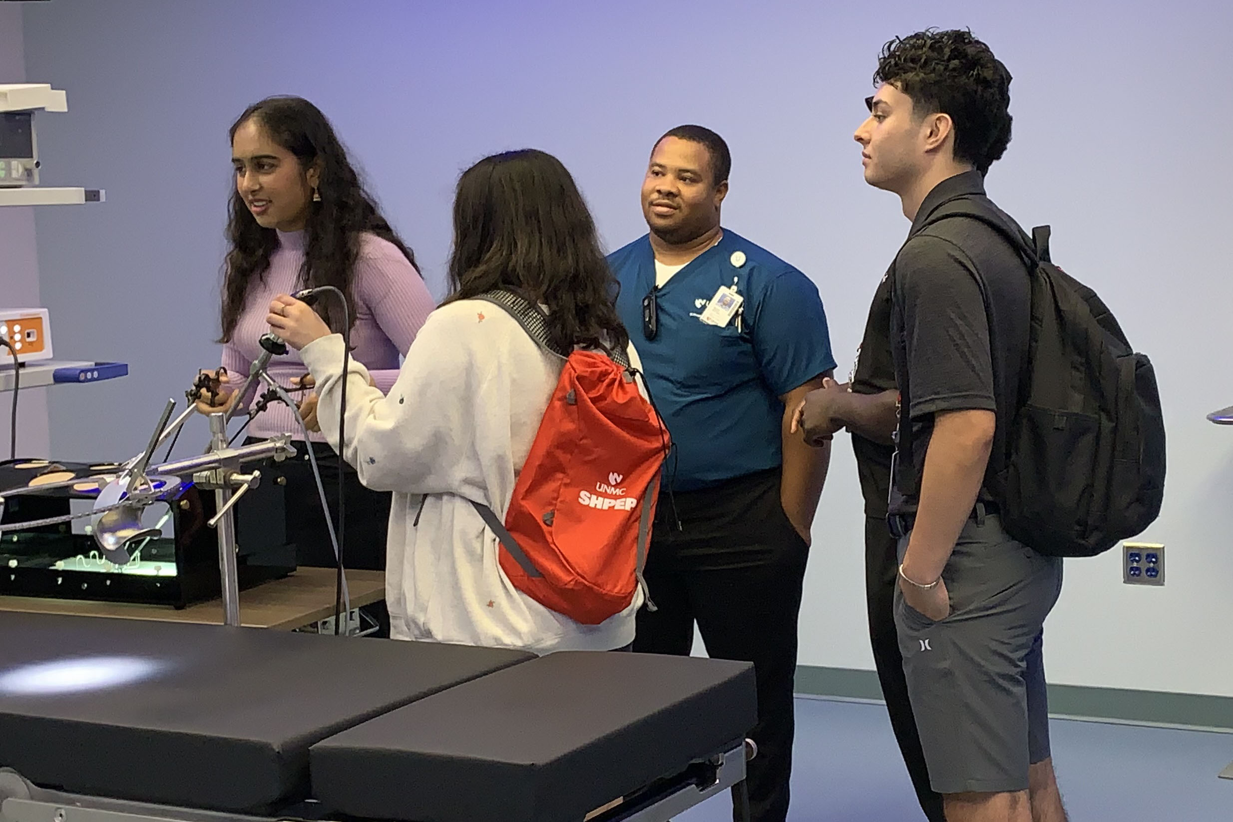 At center&comma; Wayne Howell&comma; a surgical simulation specialist and a 2017 alumnus of the Summer Health Professions Education Program&comma; works with SHPEP students visiting the iEXCEL program&period;