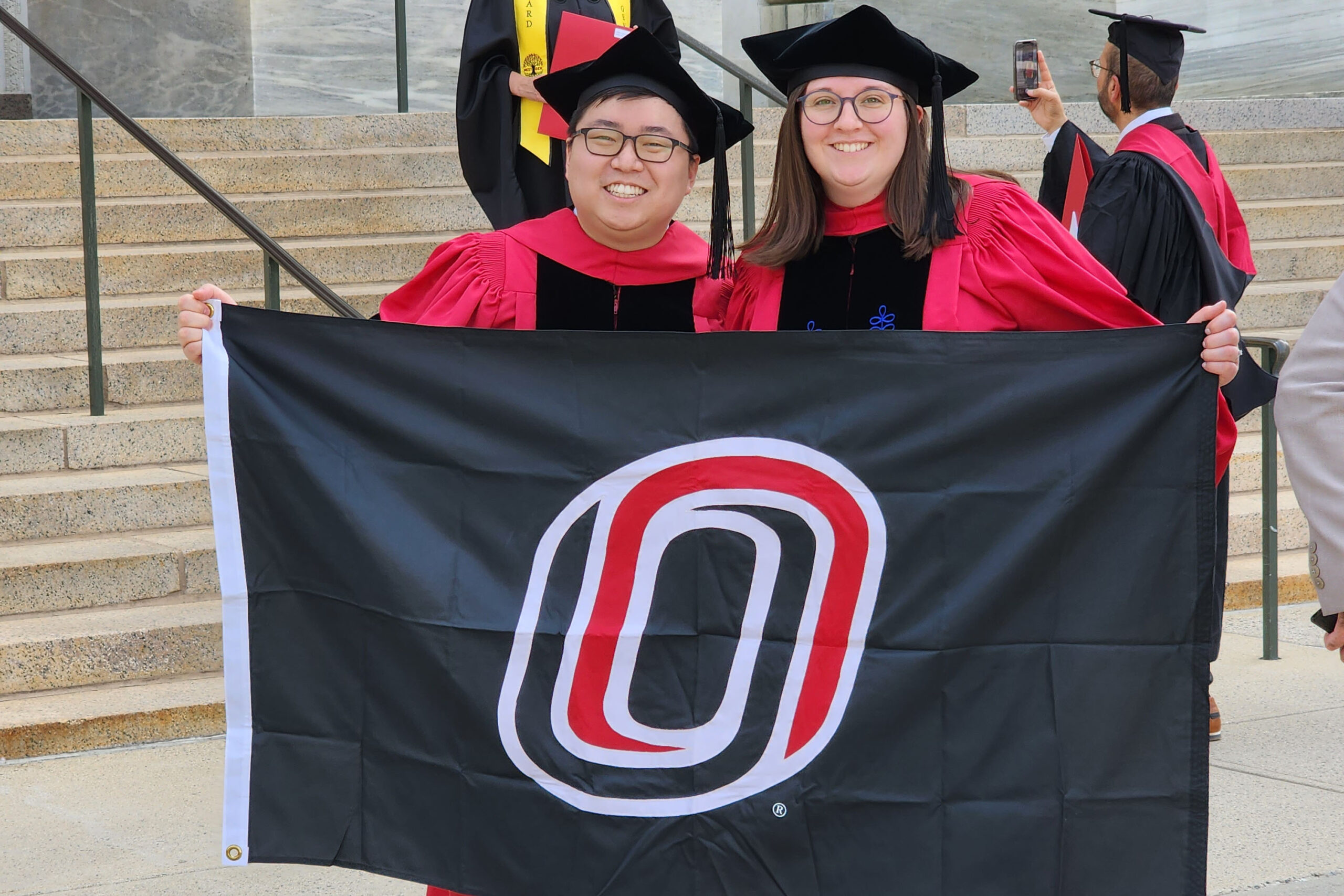 Harim Won&comma; PhD&comma; and his wife&comma; Madalyn Won&comma; PhD&comma; at the Harvard Medical School quad during commencement week for both of their PhDs in May&comma; sporting the UNO Mavericks colors&period;