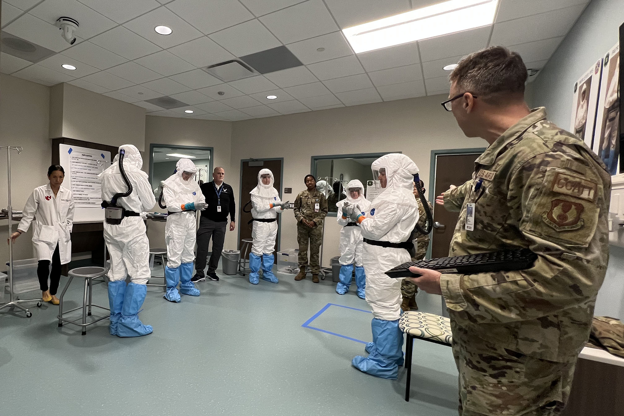 Staff members from the Center for Sustainment of Trauma and Readiness Skills&comma; or C-STARS&comma; led congressional staffers through an exercise donning and doffing personal protective equipment during a tour of the Davis Global Center&period;