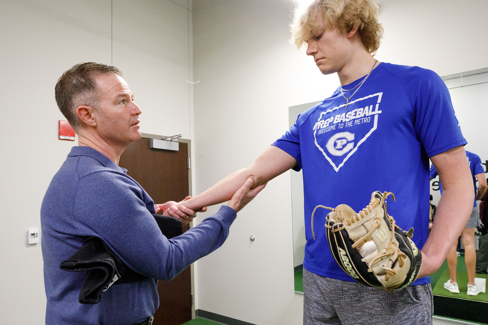 UNMC&apos;s Ed Fehringer&comma; MD&comma; works with Creighton Prep pitcher Davis Everett in a motion lab on the med center campus&period;