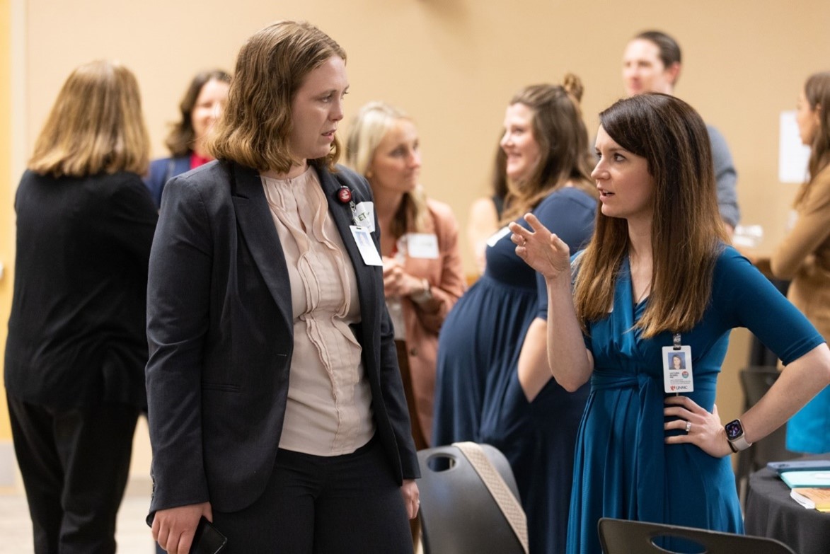 At right&comma; Victoria Kennel&comma; PhD&comma; a coach in the UNMC Office of Faculty Development&apos;s Creative Coaching program and assistant professor in the UNMC College of Allied Health Professions&comma; speaks with a colleague during the office&apos;s Interprofessional Leadership for Excellence and Academic Development graduation&period;