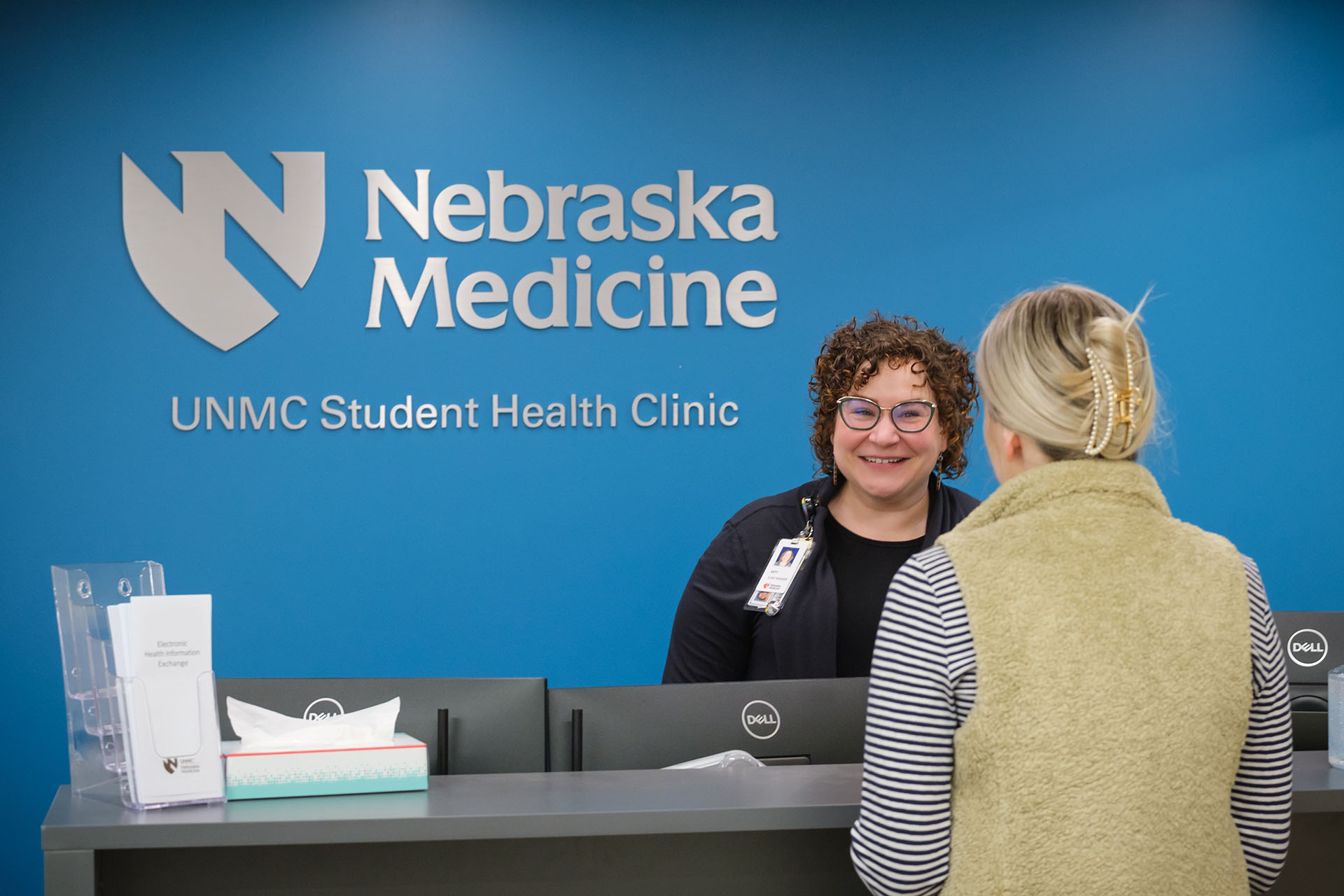 Nebraska Medicine&apos;s Katy Stratman &lpar;behind the front desk&rpar; is the clinic manager for the new Nebraska Medicine UNMC Student Health Clinic&period; Earlier this week&comma; she was at the clinic preparing for its opening&period;