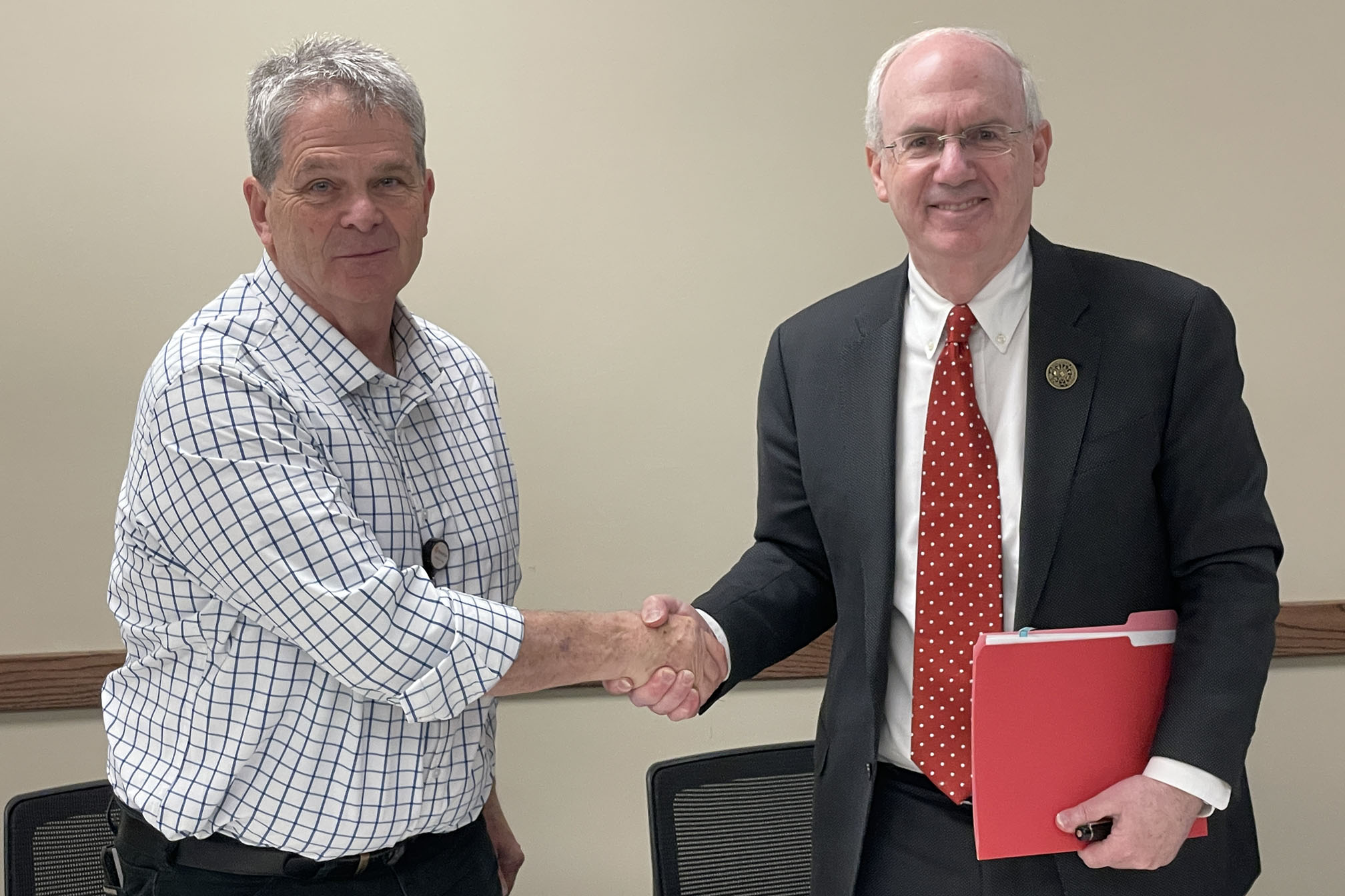 Mel McNea&comma; Regional West CEO&comma; and Jeffrey P&period; Gold&comma; University of Nebraska Medical Center chancellor&comma; finalize the agreement between Regional West and UNMC&period;