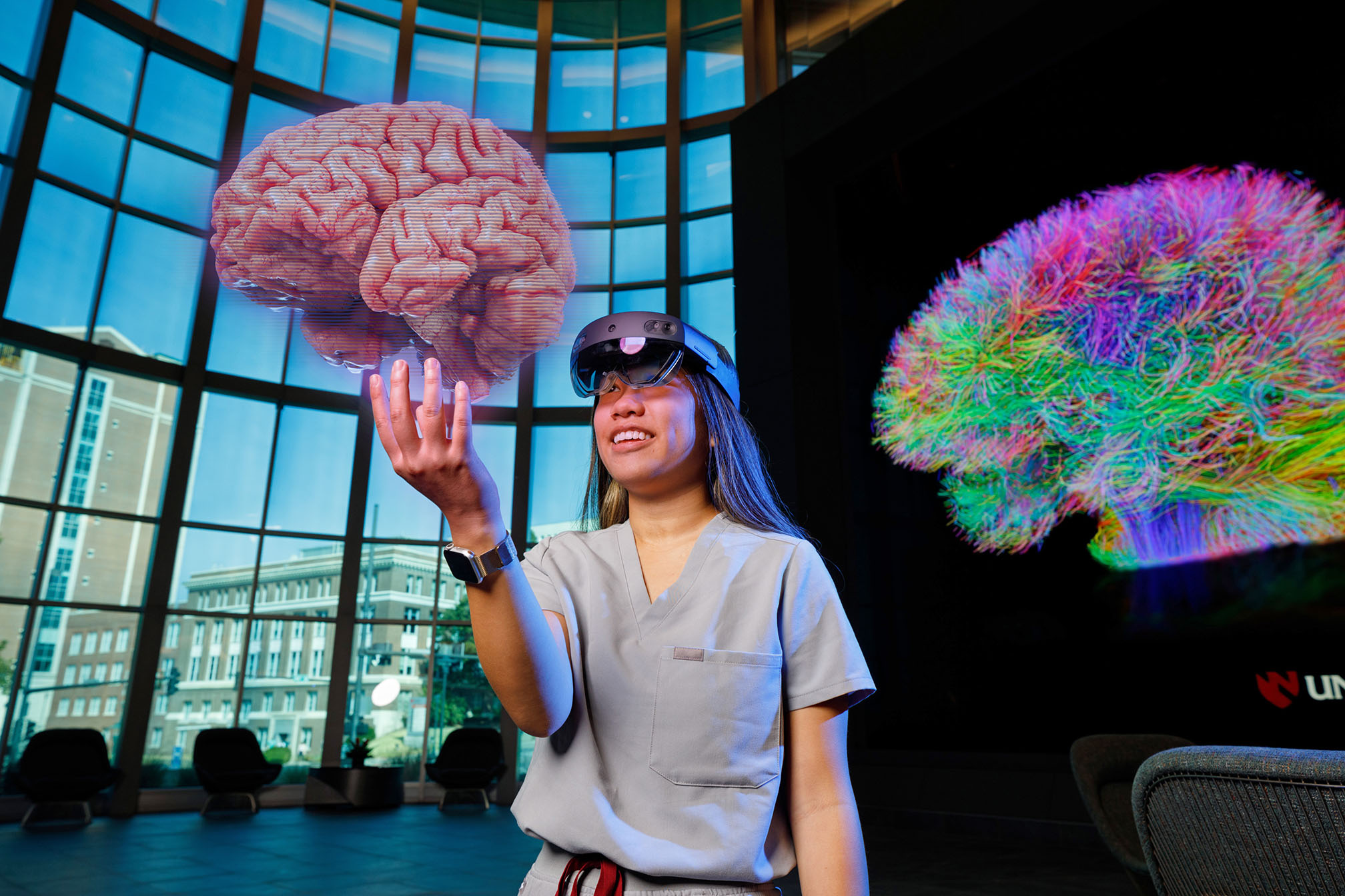 UNMC medical student Uyen Tran offers a simulated look at some of iEXCEL&apos;s health care simulation capability&comma; examining a 3D brain model based on MRI data within an Augmented Reality head mounted display&period;