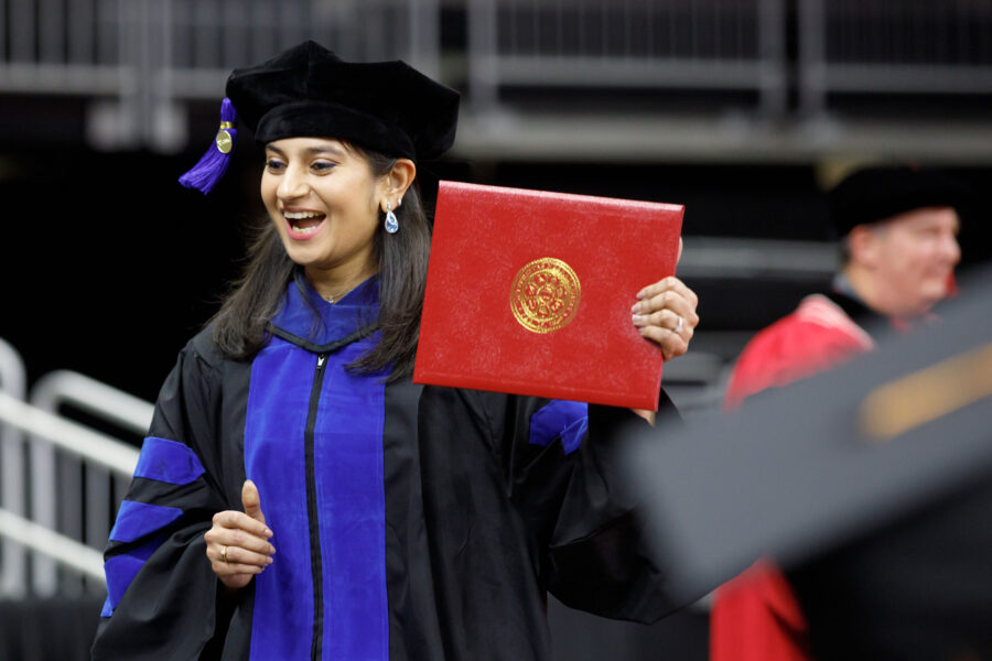 A UNMC graduate receiving her diploma