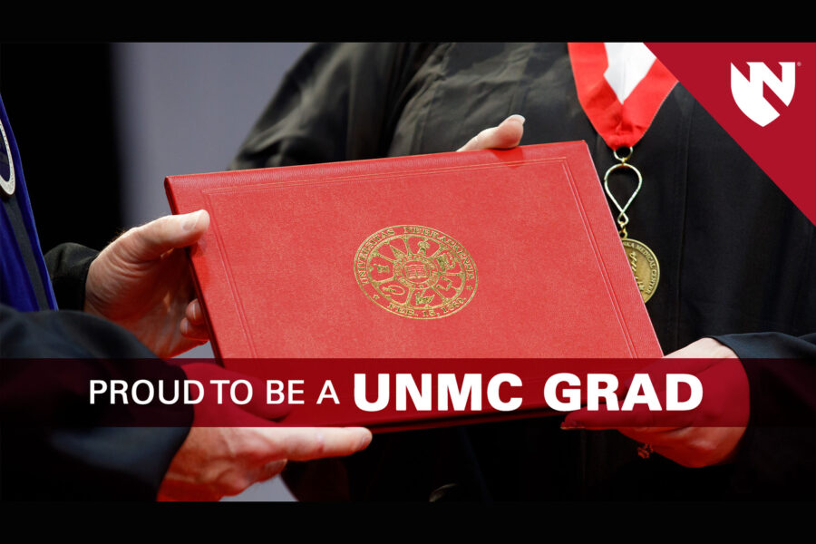 Image of a graduate receiving a UNMC diploma