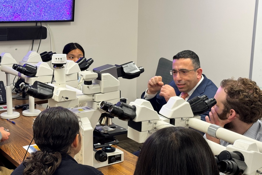 Dr. Joseph Khoury, department chairman, talks with Brownell Talbot students about pathology.