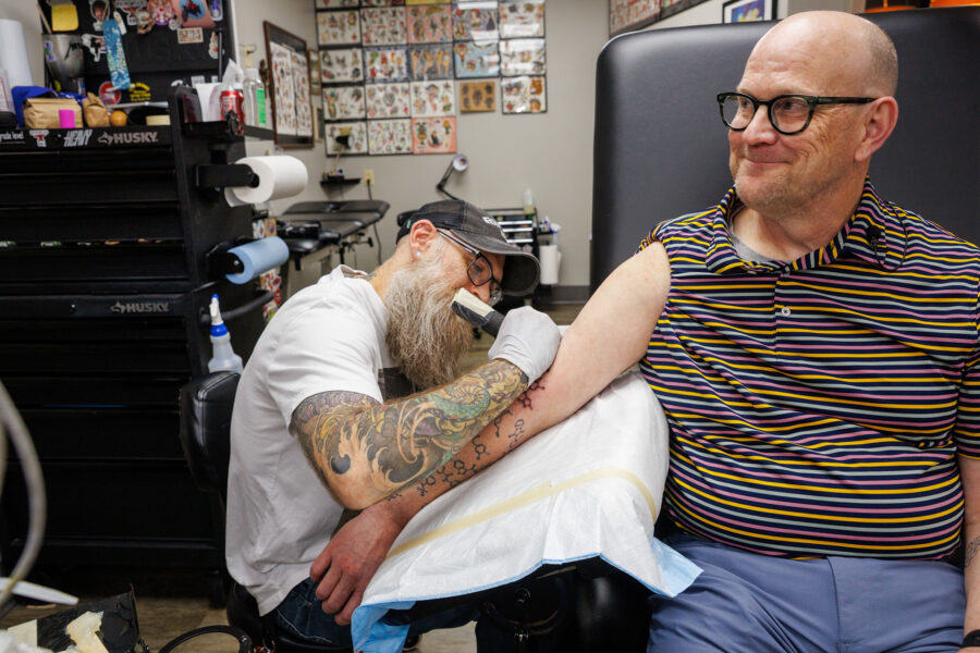 Corey Hopkins, PhD, interim chair of the department of pharmaceutical sciences, gets four new tattoos at Ironwood Ink Thursday May 1, 2025. If a student has a compound that makes it into animal testing, he has it tattooed on his arm. He currently has about 29.