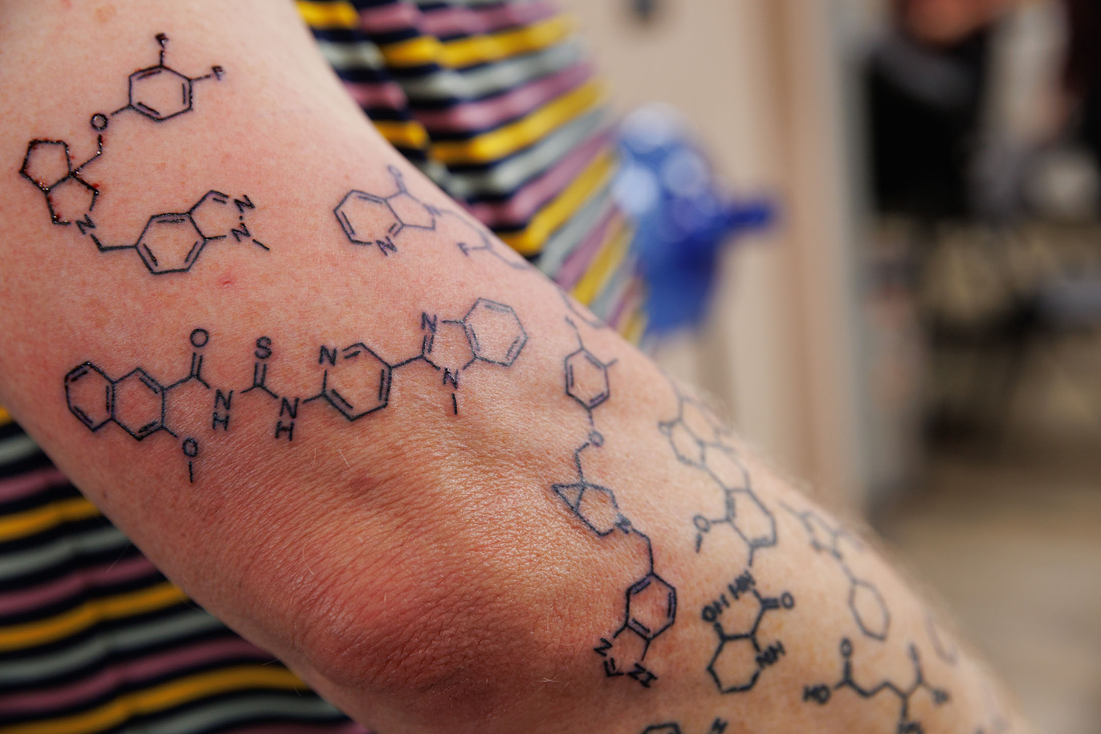 The right arm of Corey Hopkins, PhD, showing his tattoos of the chemical compounds created by his students.