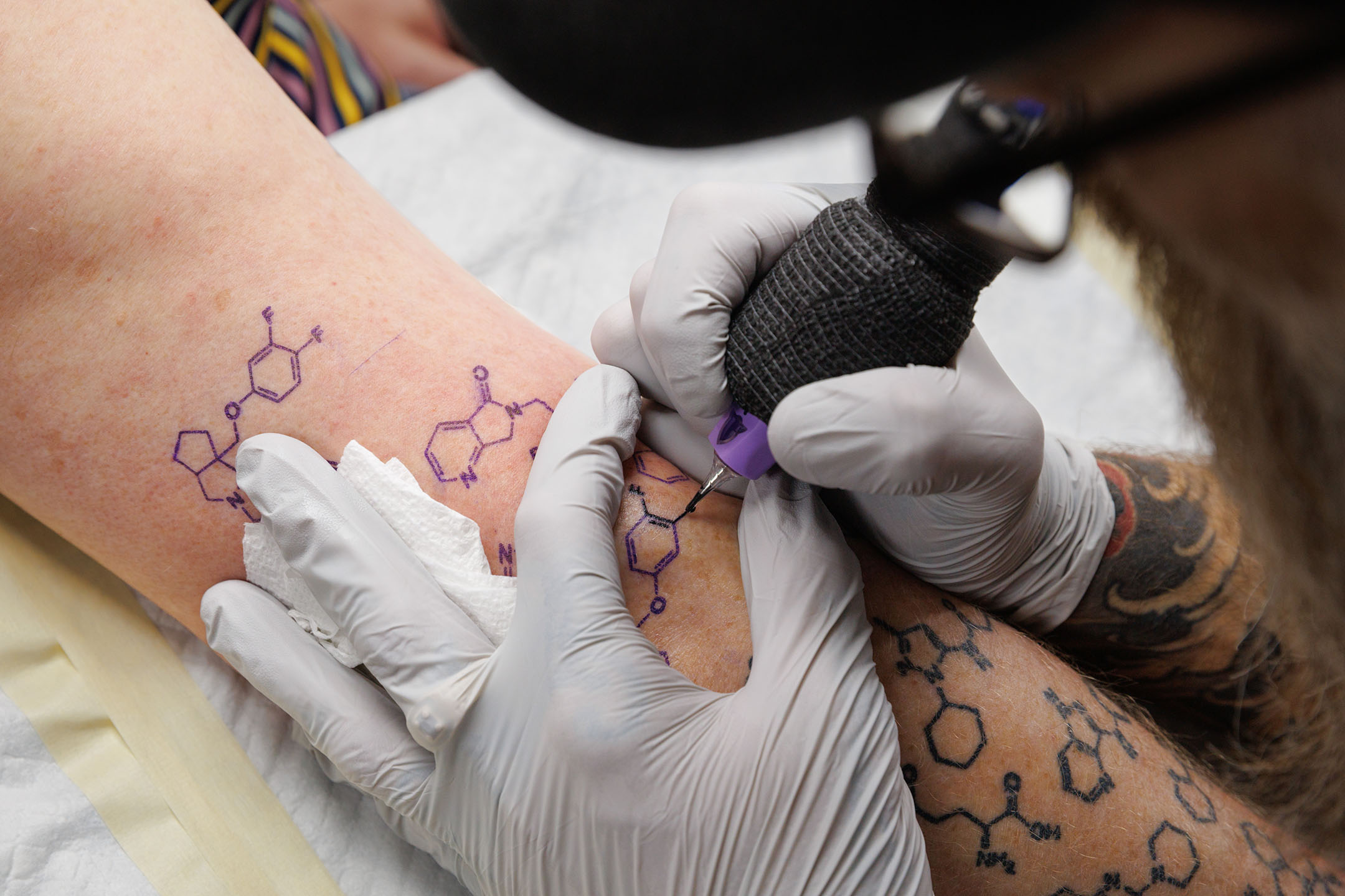 The right arm of Corey Hopkins, PhD, showing his tattoos of the chemical compounds created by his students.