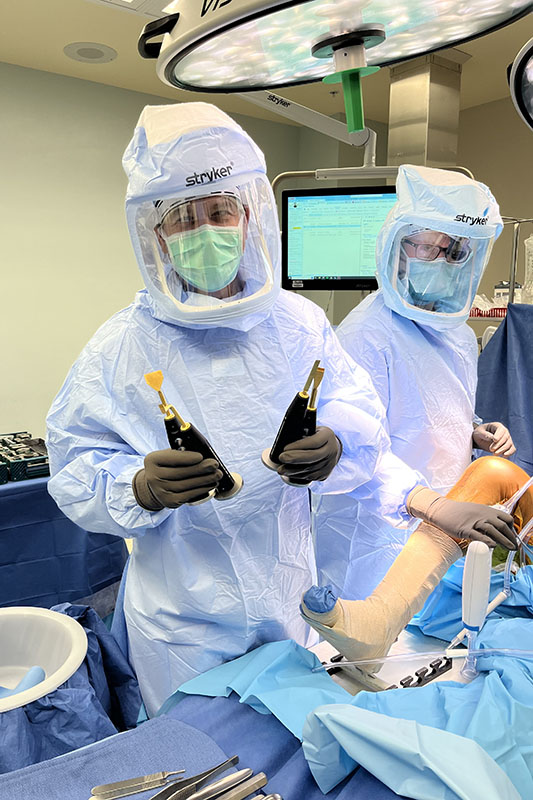 Beau Kongisberg, MD performing surgery with a surgical tool he helped modify.