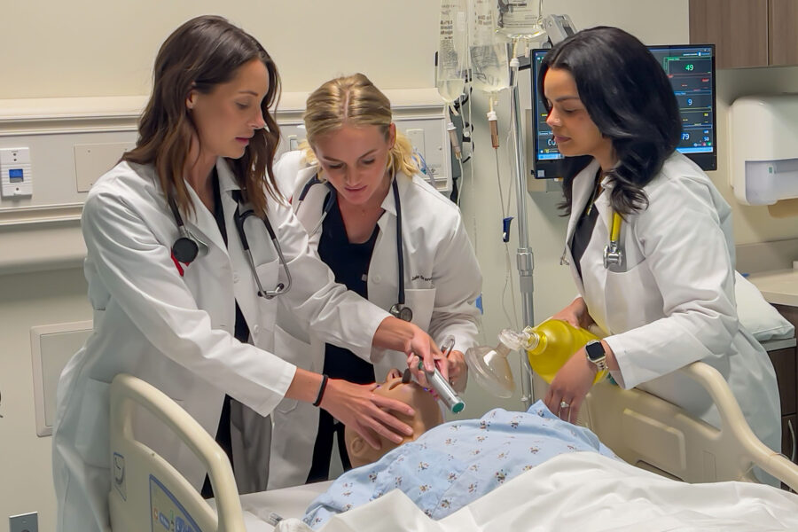 Haley Hays&comma; DNP&comma; UNMC College of Nursing&comma; leads an intubation exercise with nursing students Laura Rogers and Jamie Granatowicz in the simulation lab at the Davis Global Center on the Omaha campus&period; The exercise will be part of the Emergency Nurse Practitioner Post-Graduate Certificate program&comma; which welcomes its first cohort in January 2026&period;