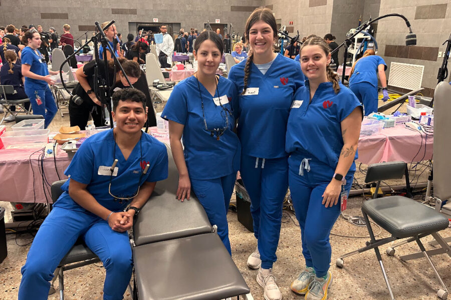 Dental hygiene students Juan Cervantes, Fatima Anguiano, Baili Kumpf and Grace Ehly prepare for patients to arrive at the event.