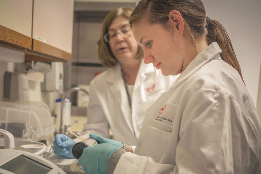 SHARING Clinic faculty volunteer&comma; Ricki Otten&comma; and student volunteer Kaitlyn Walton&comma; process laboratory samples at the Leavenworth clinic location&period;