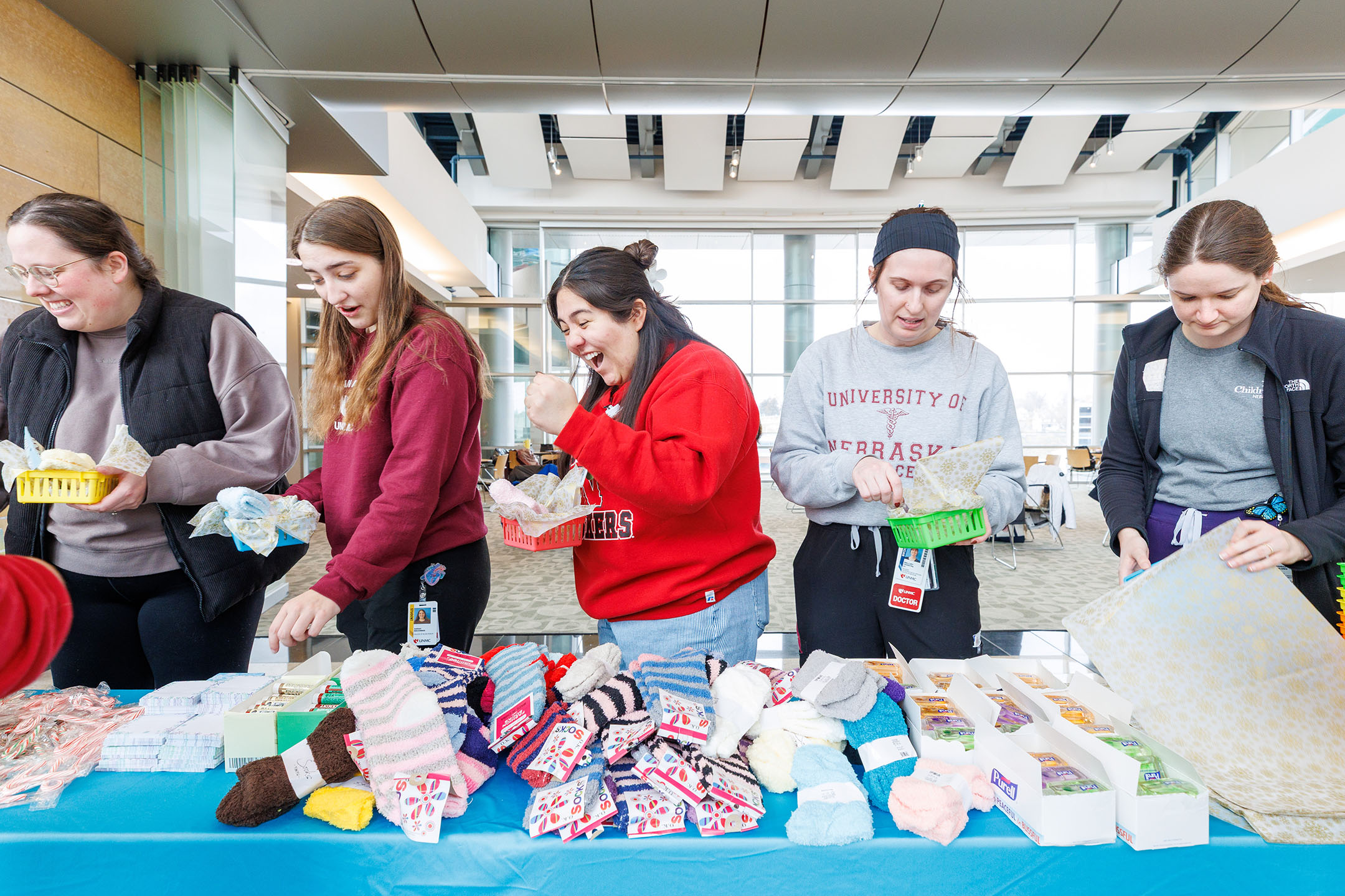 Students smile in the line to make Cozy Baskets