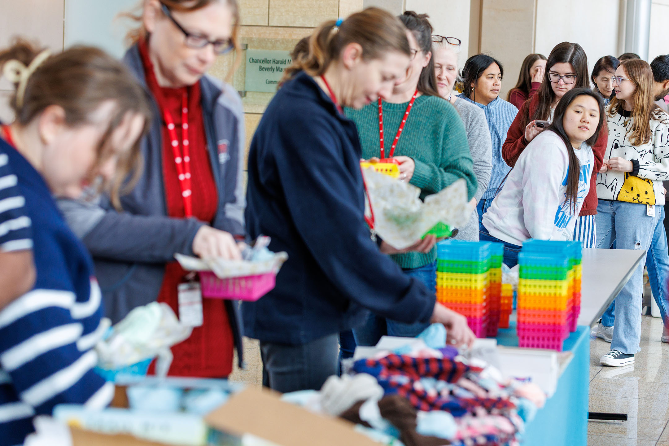 A look at the long line of people waiting to make a Cozy Basket while a student looks forward to see what's ahead