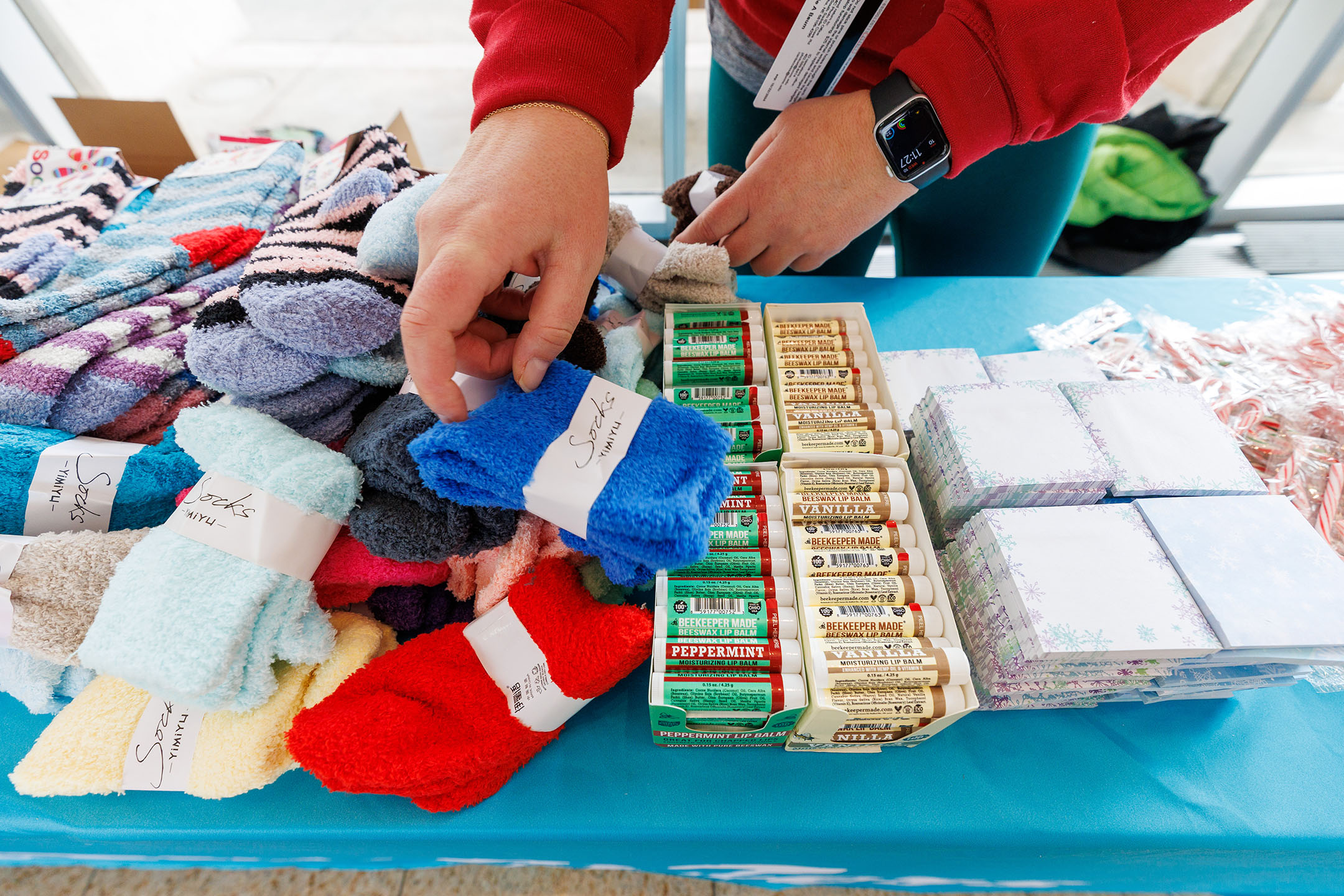 An image of an event coordinator arranging goodies at the Cozy Baskets event
