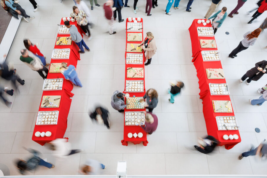 A view of the Wigton Heritage Center and Chancellor's Holiday Tea from above as people file through tables to get cookies