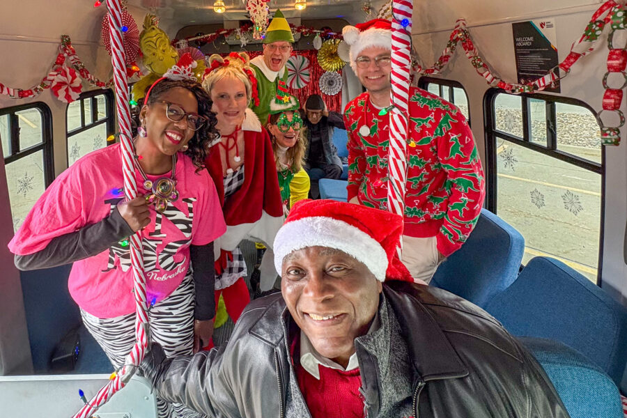 Interim Chancellor H&period; Dele Davies&comma; MD&comma; wearing a Santa hat aboard a festive shuttle with other participants in the 2025 holiday video