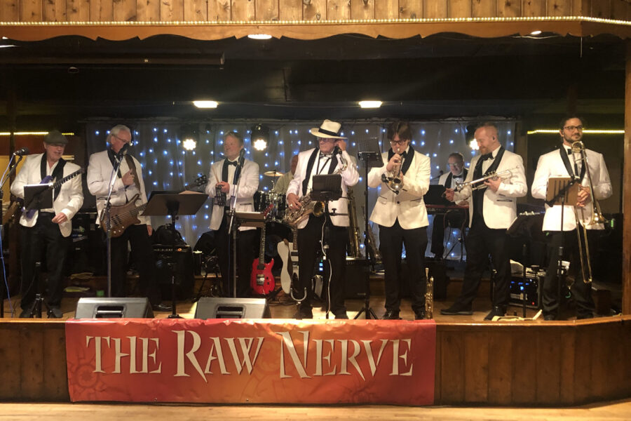 Raw Nerve performs&period; Steve Pejsar&comma; DDS&comma; is second from left&semi; Jim Jenkins&comma; DDS&comma; is to the right of Dr&period; Pejsar with a tambourine&semi; Bob Schoettger&comma; DDS&comma; is in the back row at right on keyboards&period; Bruce Bavitz&comma; DMD&comma; is not pictured&period;