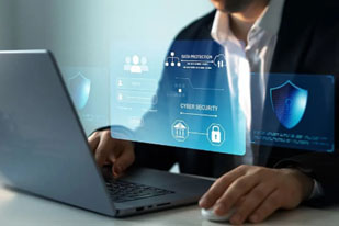 A man sitting at a laptop with cybersecurity alerts showing in the foreground