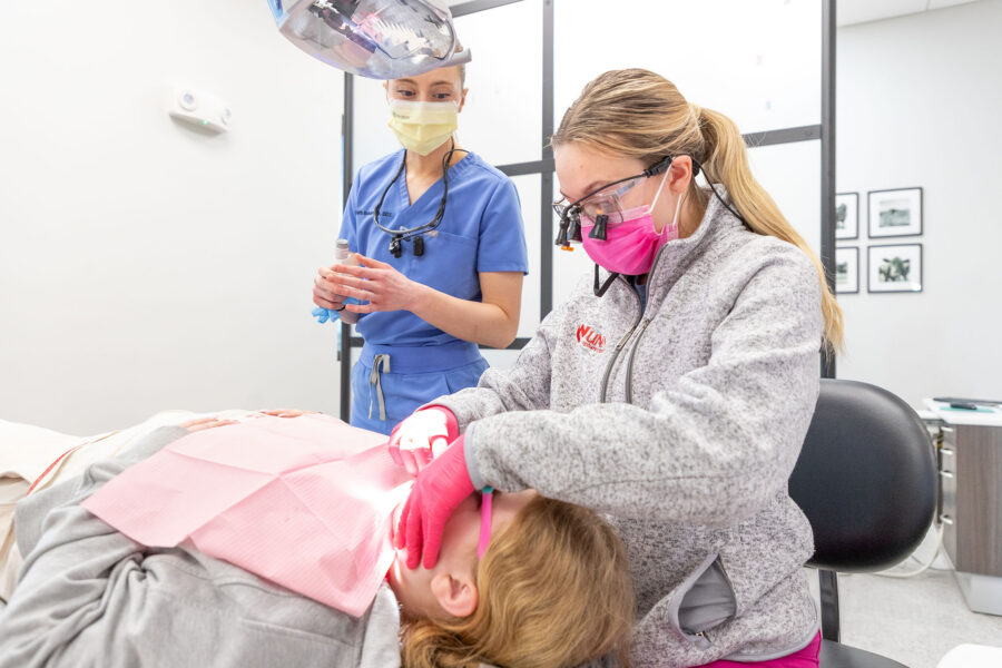 From right&comma; dentistry residents Lauren Wright&comma; DDS&comma; and Beth Beberwyk&comma; DDS&comma; care for a pediatric patient at a Children&rsquo;s Dental Day event in York&comma; Nebraska&period;