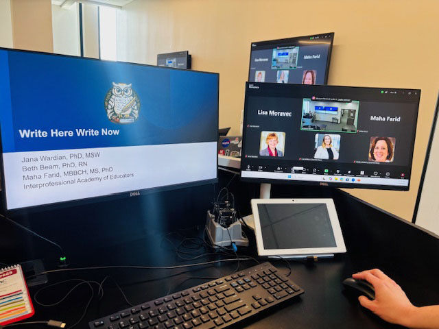 An image of a desktop computer setup with two monitors and a keyboard, previewing the IAE Writing Workshop on the screens
