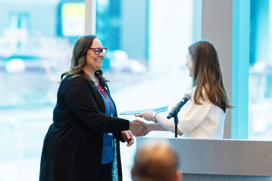 Pamela Dickey&comma; assistant professor in the UNMC College of Allied Health Professions&comma; receiving her iEXCEL Innovation Award from Sarah Kriss&comma; manager for the advanced human simulation program&period;