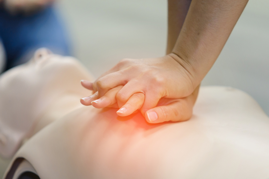 Image of a responder providing chest compressions on a medical manekin
