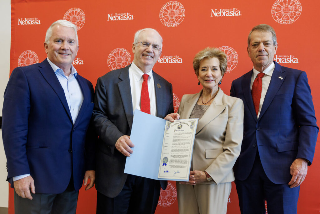 From left, Tim Clare, NU regent, Jeffrey P. Gold, MD, president of the University of Nebraska System, Linda McMahon, United States secretary of education, and Jim Pillen, governor of Nebraska, pose for a photo holding the proclamation of joint accreditation between the University of Nebraska-Lincoln and University of Nebraska Medical Center inside the Osborne Legacy Complex.