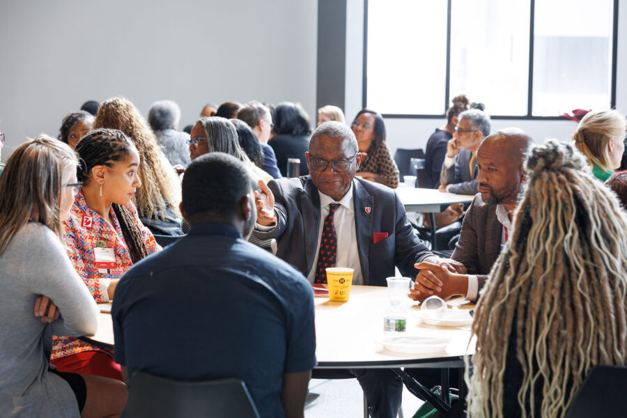 H&period; Dele Davies&comma; MD&comma; UNMC interim chancellor&comma; talks with a table of UNMC and North Omaha community representatives at the April 8 North Omaha Leadership Breakfast&period;