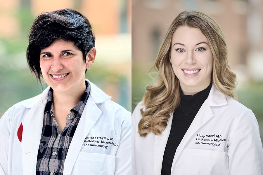 two women in white lab coats