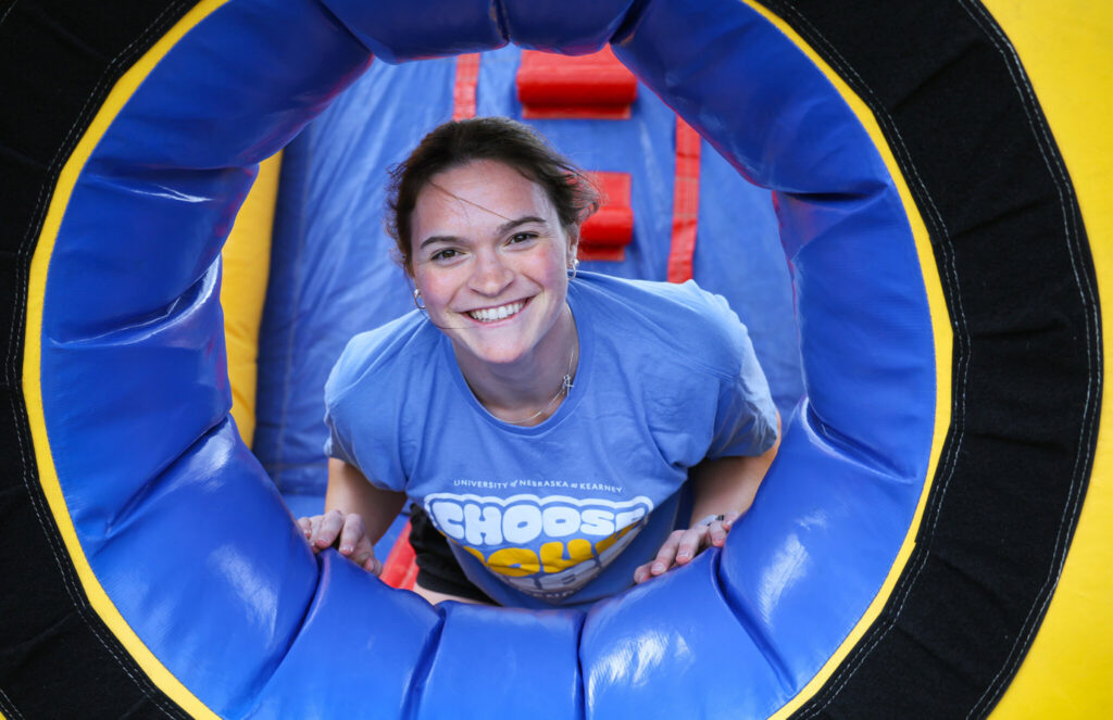 Elly Piper poses for a photo inside an inflatable bounce house during a UNK Residence Life event. She served three years as a resident assistant, guiding new students and fostering community in the residence halls.