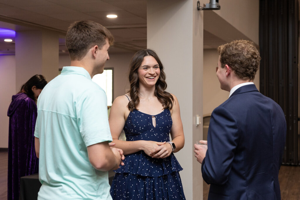 Elly Piper attends the Applauding Excellence awards ceremony at UNK, where she was recognized with the Outstanding Senior Award. Here, she talks with two other students at the event.