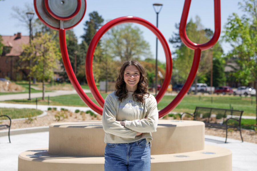Elly Piper is photographed next to the stethoscope sculpture "Healing&comma;" a replica of the original at UNMC's Omaha campus that has been installed in Kearney&period;