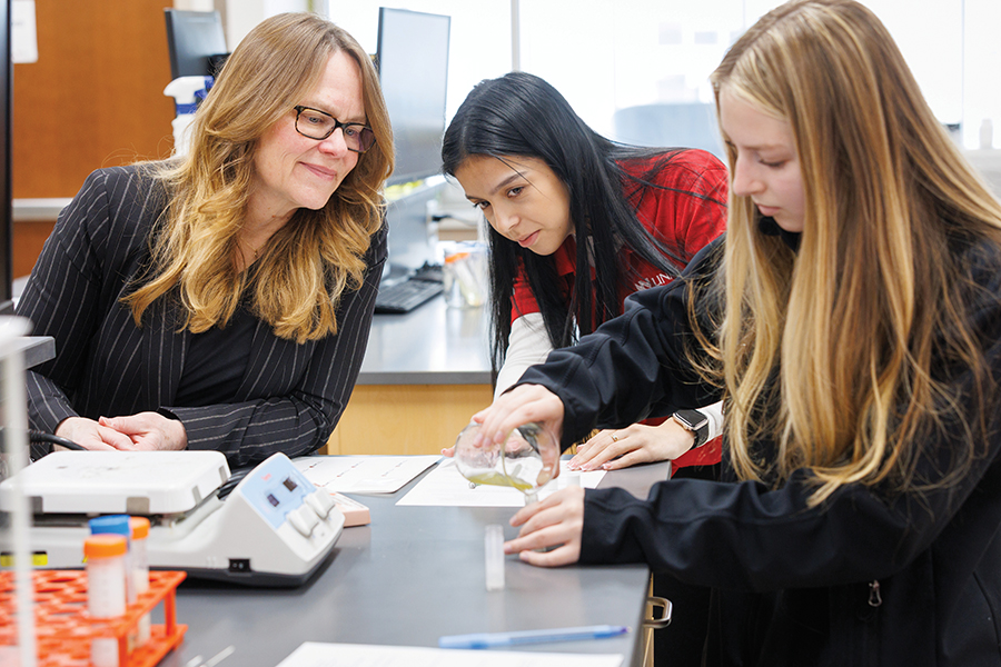 Heidi Kaschke&comma; director of the High School Alliance&comma; guides budding scientists in a lab experiment&period;