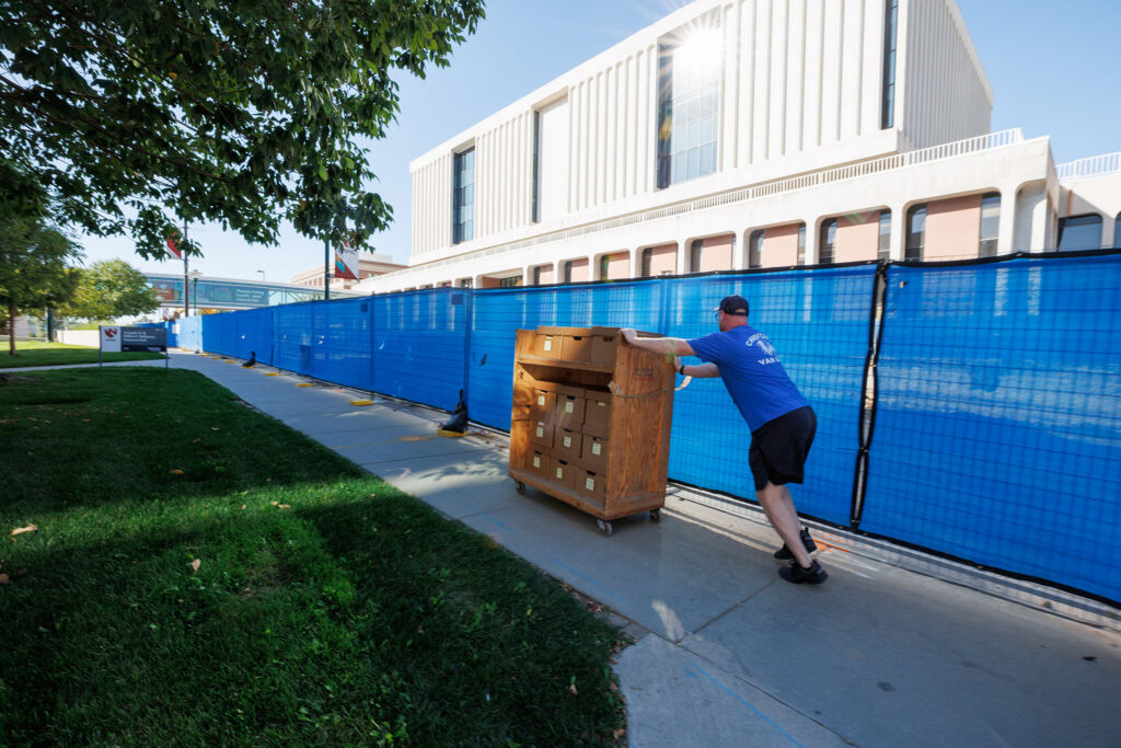 Items from the College of Nursing and alumni museum were moved to the McGoogan Library Friday Sept. 26, 2025. The archives were being donated to the library for preservation. Here, a mover ferries a cart along 42nd Street.