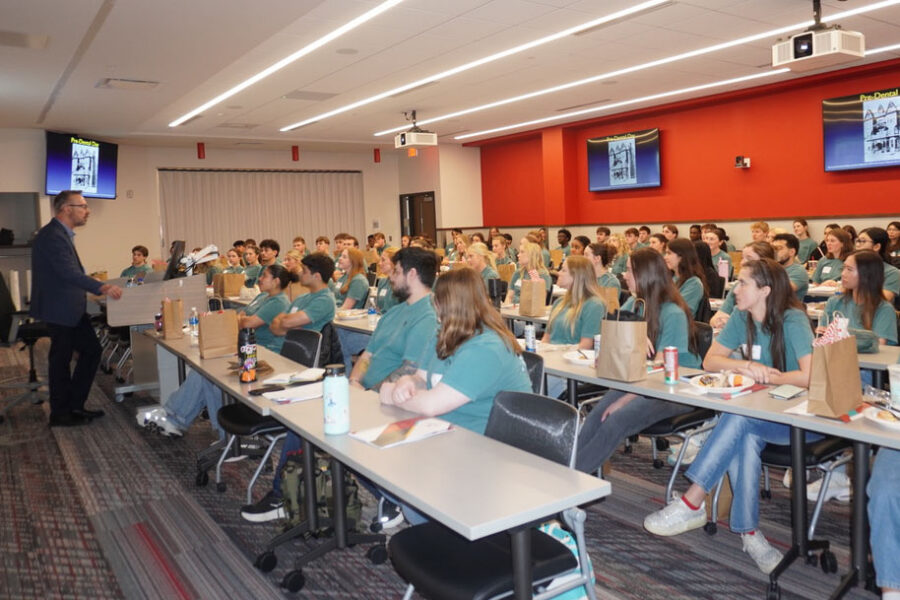 UNMC College of Dentistry Dean Gerard Kugel&comma; DMD&comma; PhD&comma; at left&comma; speaks to the undergraduate college students attending April&rsquo;s annual Pre-Dental Day at the UNMC College of Dentistry&period;