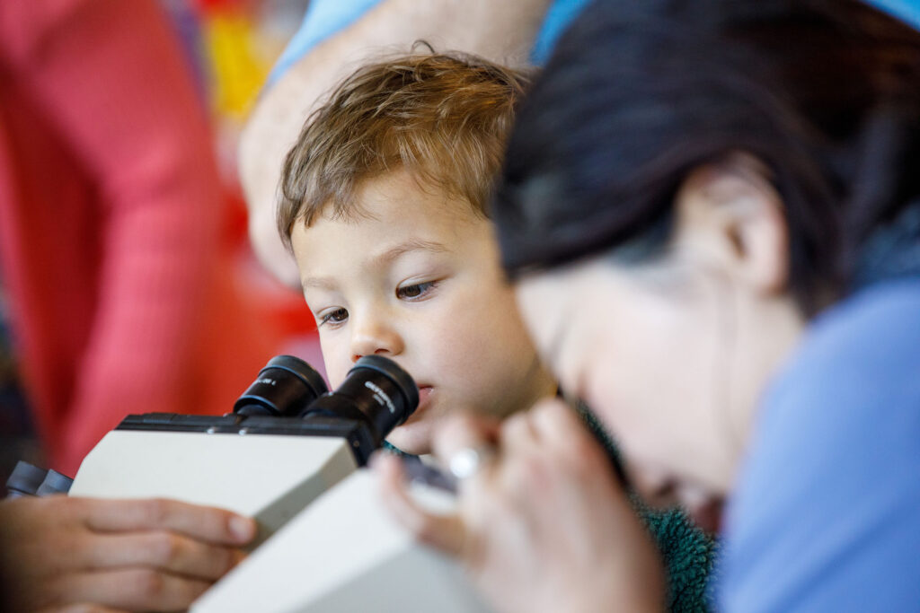 The Durham Museum was host to Durham Science Day Saturday April 18, 2026. Dozens of booths were set up around the museum with displays and hands-on activities to teach about science and the environment. More than 800 people attended the event. Here, two young children look into microscopes.