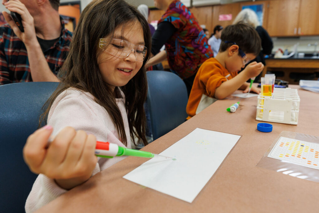 Metro Community College science day was held Saturday April 11, 2026, at the south Omaha campus. There were multiple rooms full of a variety of science experiments and displays for kids of all ages. Here, two young children wear goggles and work with droppers and colored liquid to simulate science experiments.