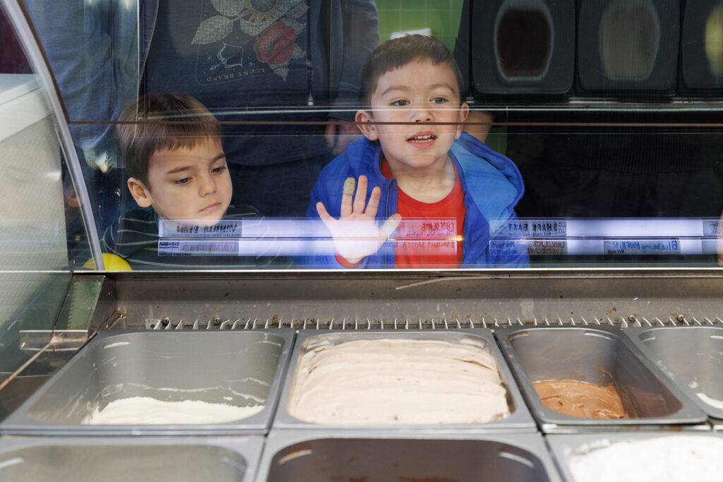 eCreamery in Dundee participates in the Nebraska Science Festival with a special event for kids ages 12 and under. First attendees watch experiments using dry ice and talk about how ice cream can be shipped using dry ice. Then each participant got to pick out their favorite flavor for a scoop to eat, and two young children here look over the ice cream selection.