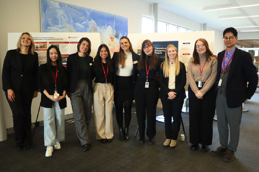 Nine attendees at last year's poster session pose for a photograph.