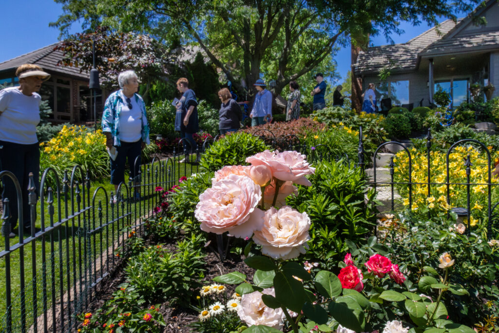 Spectators view plants and flowers at a featured garden during the Munroe-Meyer Guild's Garden Walk.