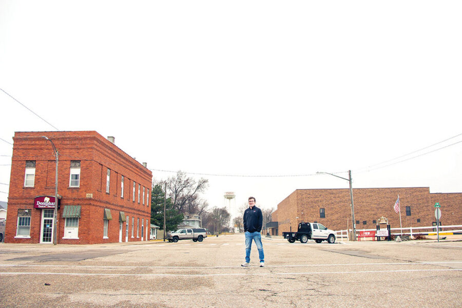 UNMC pharmacy student Carter Schultz stands in the middle of the street in his hometown of Doniphan, Nebraska.