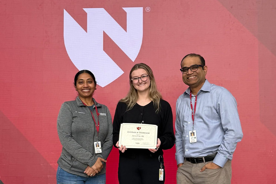 Anna Frie poses with Sowmya Yelamanchili, PhD, and Gurudutt Pendyala with her award certificate.