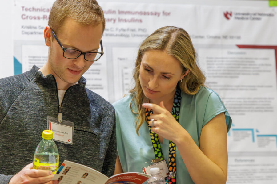 House officers Nicole Kusnik&comma; MD&comma; and Calvin Albrecht&comma; MD&comma; in disucssion at the GME Research Symposium&period;