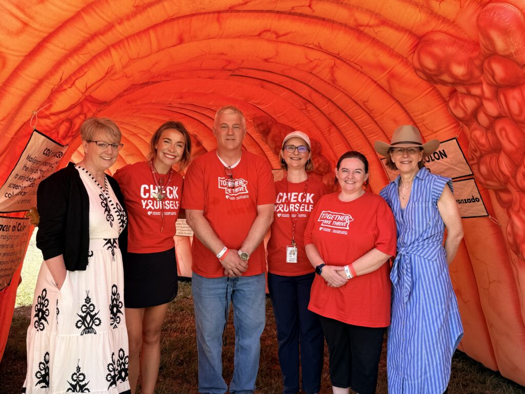 Cancer center faculty and staff in an inflatable colon
