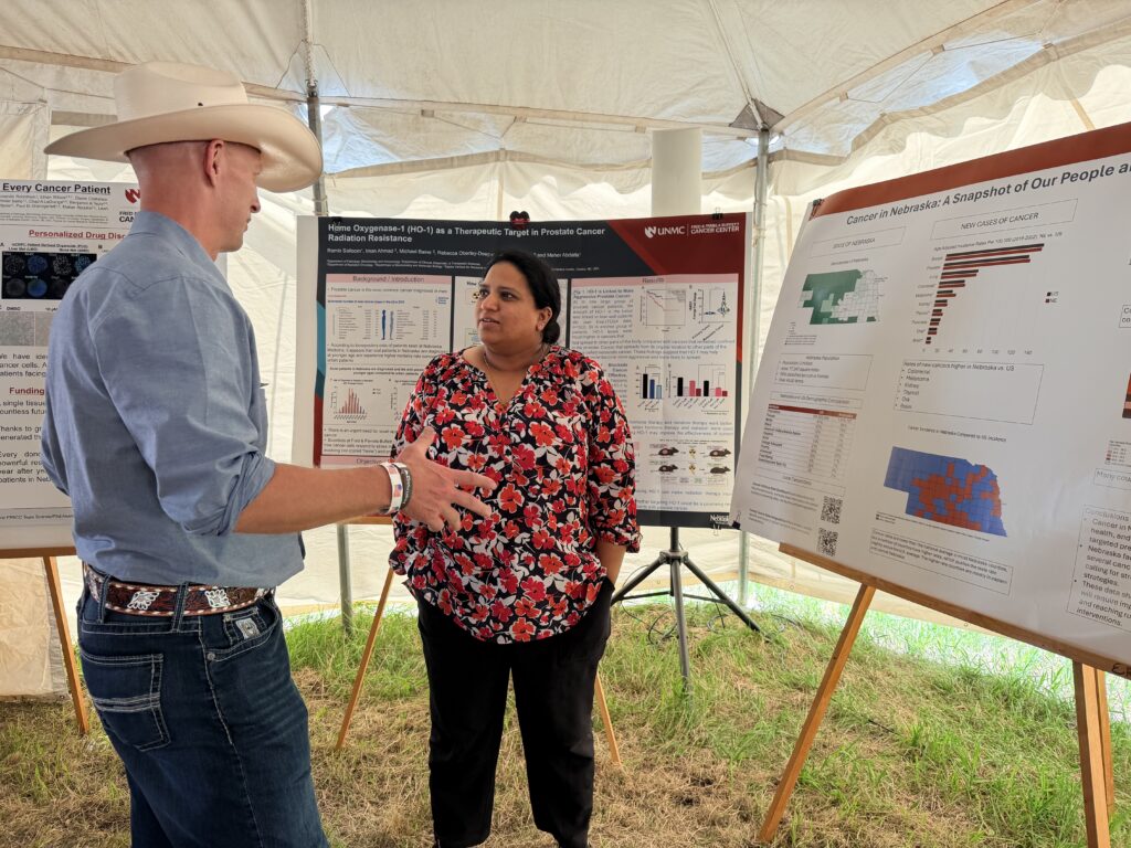 Dr. Mathew presenting her poster to an attendee