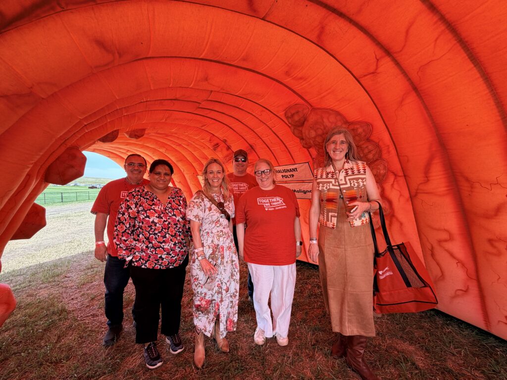 Cancer center faculty in an inflatable colon