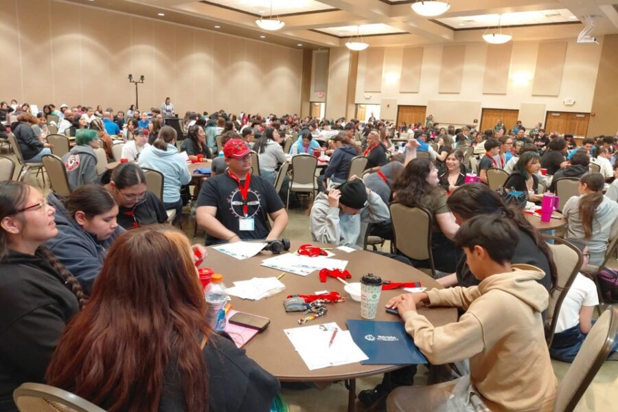 youth gathered at round tables